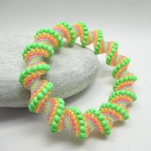 Blacklight reactive Cellini Spiral beadwoven bangle